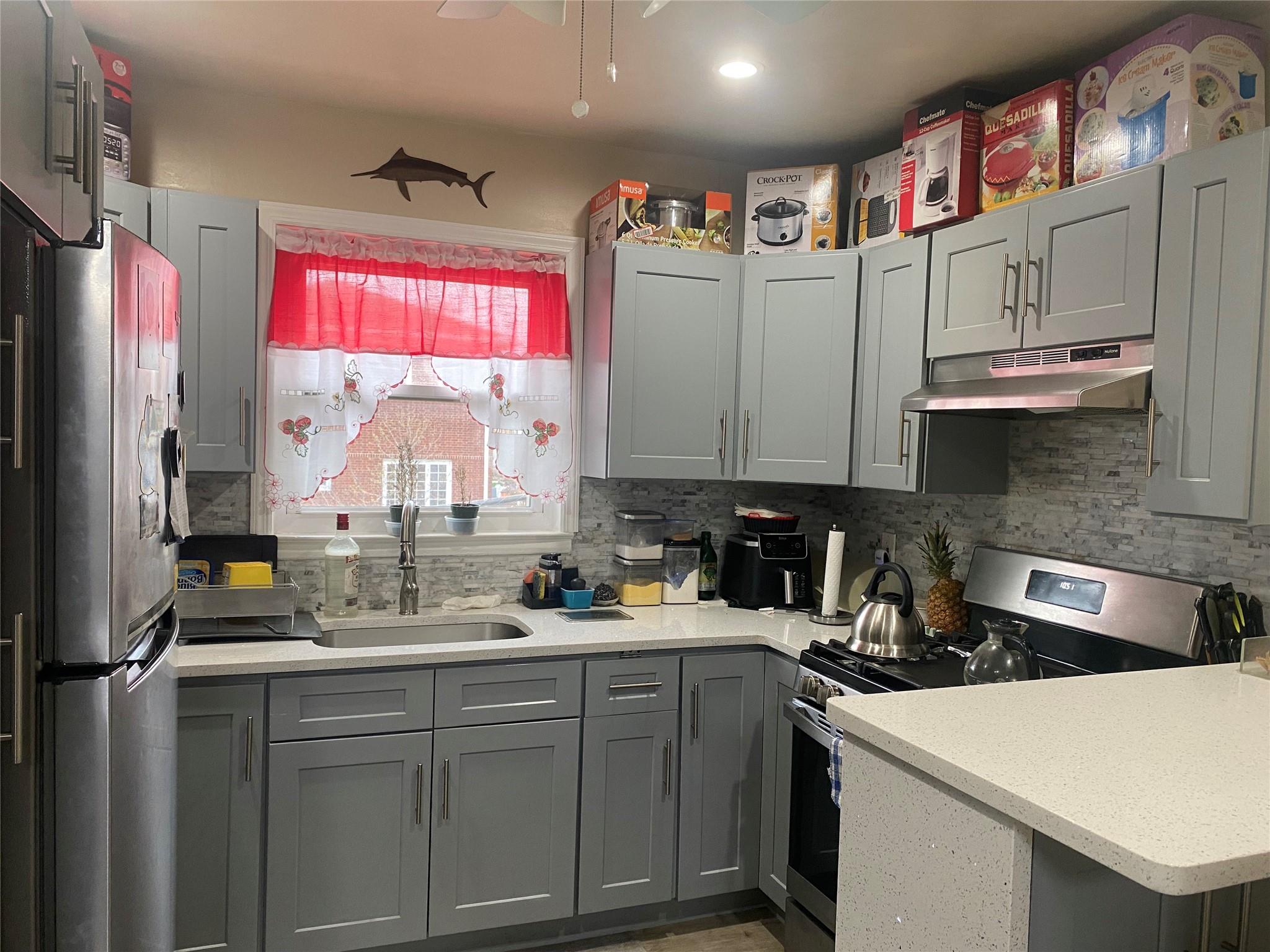 106-60 Ditmars Boulevard Queens, NY 11369 - Photo 5 of 12 a kitchen with stainless steel appliances granite countertop a sink stove and cabinets