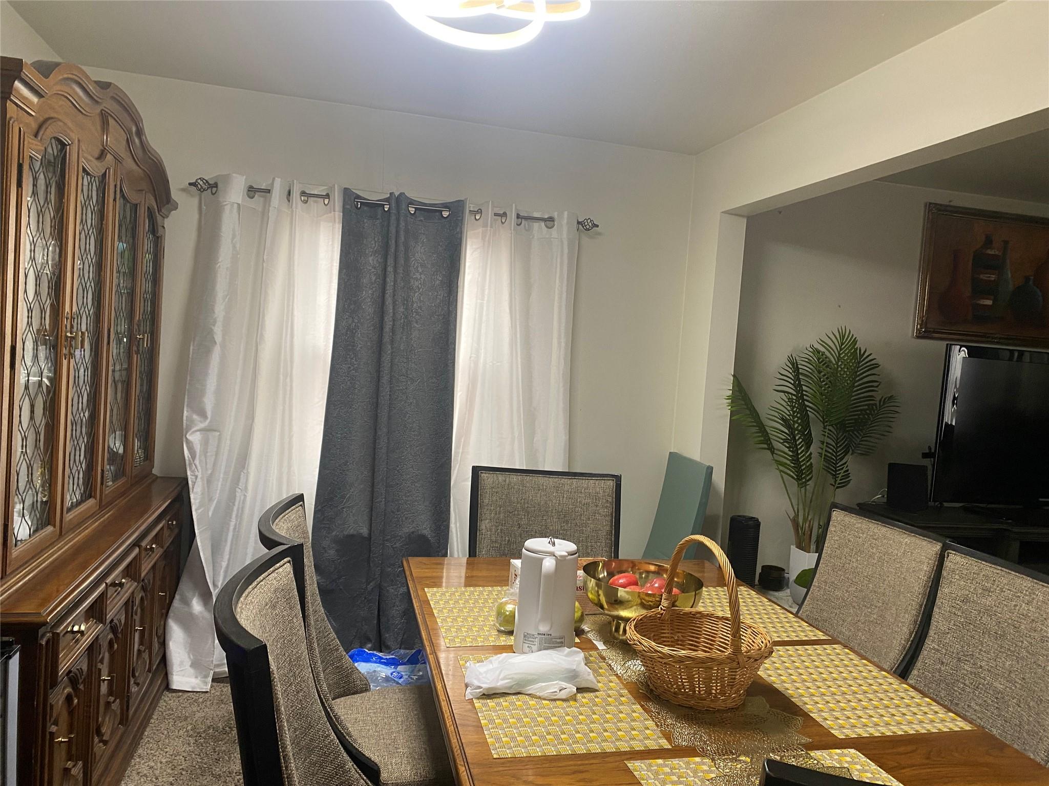 106-60 Ditmars Boulevard Queens, NY 11369 - Photo 7 of 12 a living room with furniture and a flat screen tv