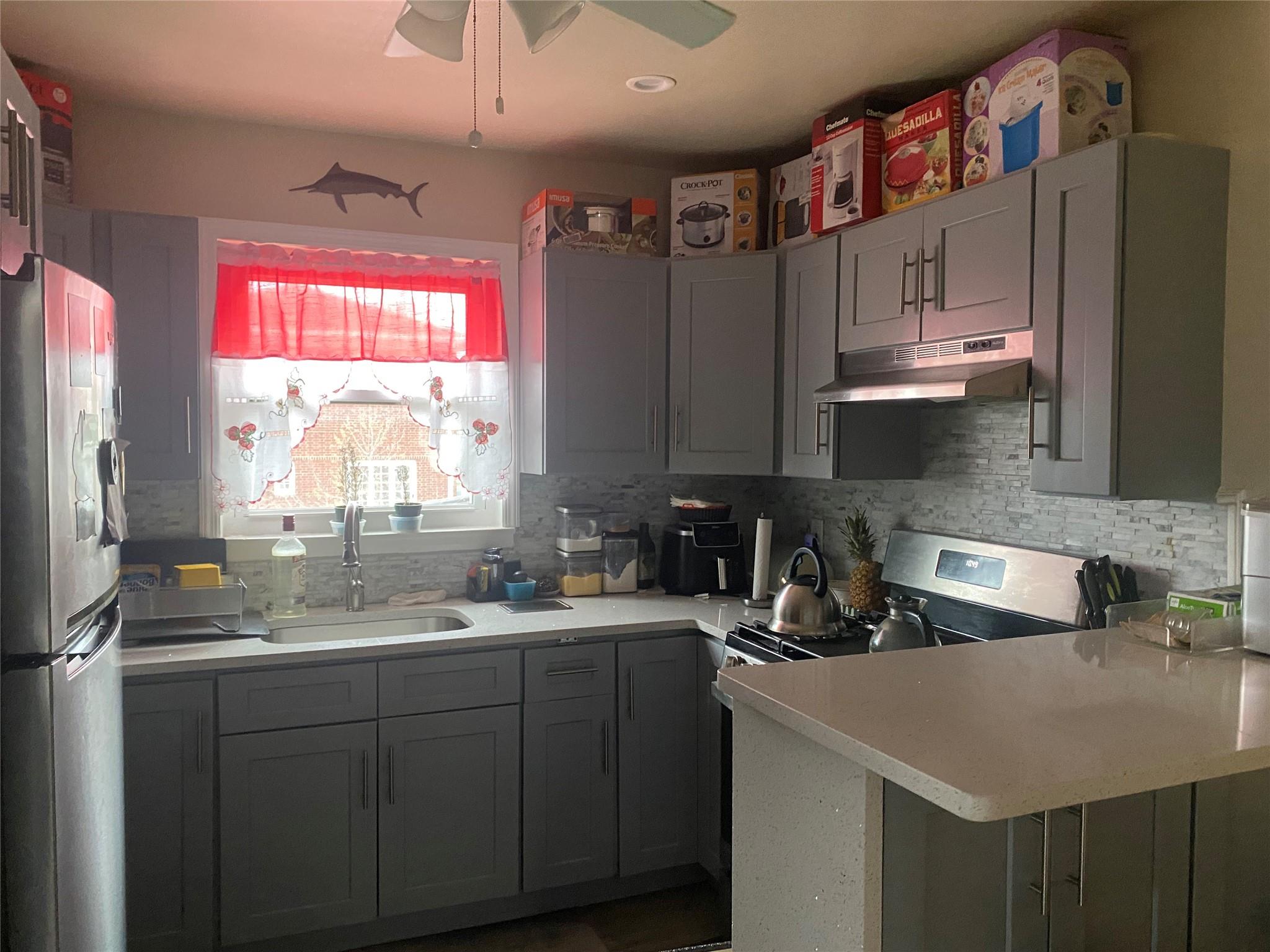 106-60 Ditmars Boulevard Queens, NY 11369 - Photo 9 of 12 a kitchen with stainless steel appliances a sink a stove and a refrigerator