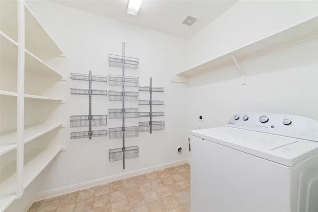 a view of storage and utility room with washer and dryer