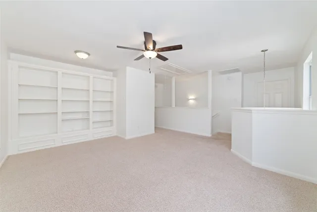 an empty room with a empty space and windows