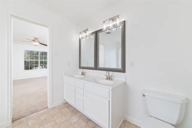 a bathroom with 2 sink and a mirror