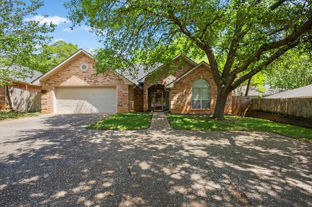 2824 Crestview Avenue Tyler, TX 75701 - Photo 2 of 39 a front view of a house with a garden and trees