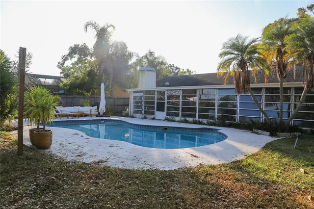 a view of a house with backyard and sitting area