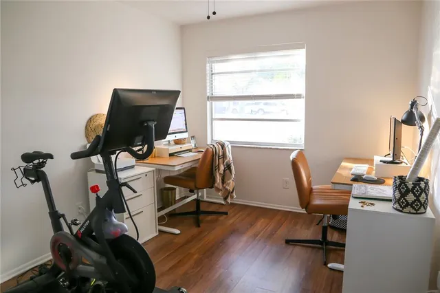 a view of a workspace with furniture and a window