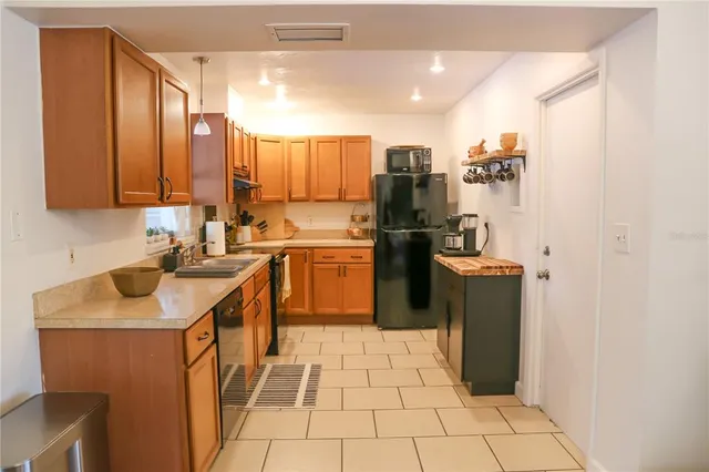 a kitchen with stainless steel appliances a sink stove and refrigerator