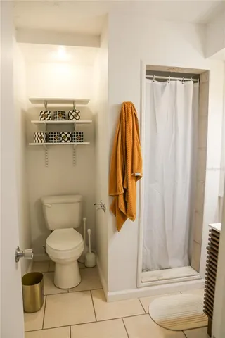 a bathroom with a toilet and a shower