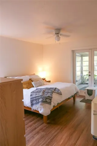 a bedroom with a bed and wooden floor