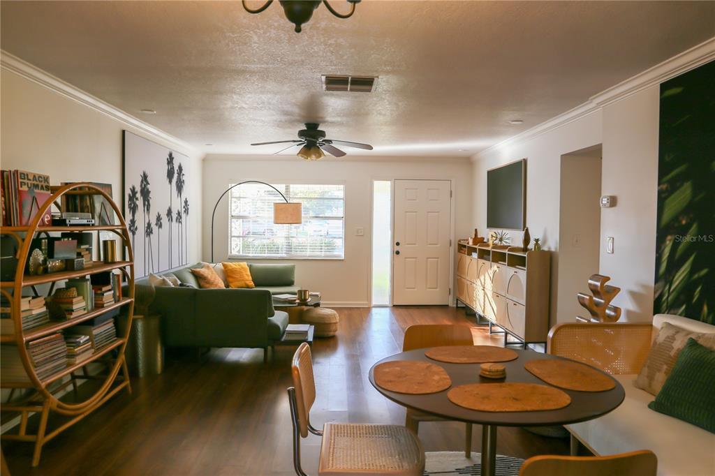 1810 Copper Kettle Lane Dunedin, FL 34698 - Photo 5 of 22 a living room with furniture a flat screen tv and a table