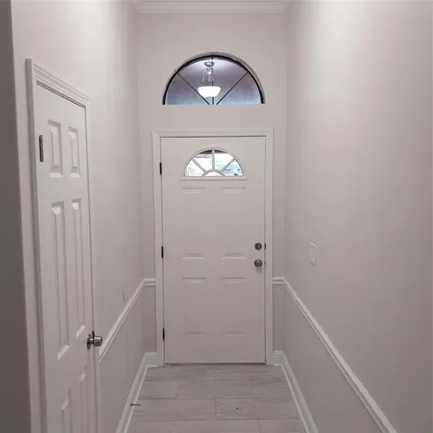 a view of a hallway with wooden floor and a hallway
