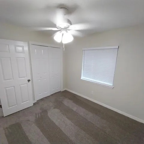 a view of an empty room with a fan