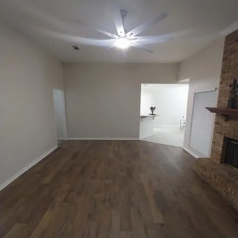 a view of empty room with a fireplace