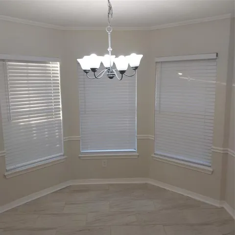 a view of a chandelier fan and wooden floor