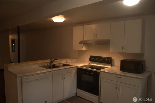 a kitchen with a sink and cabinets