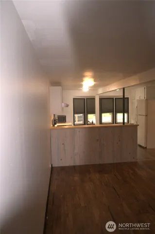 a view of an empty room and wooden floor
