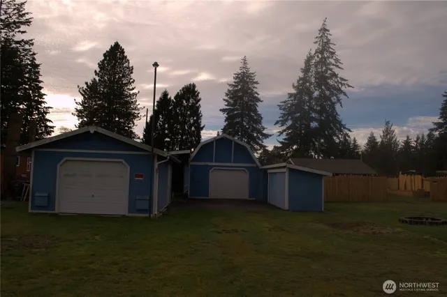 a front view of a house with a yard and trees