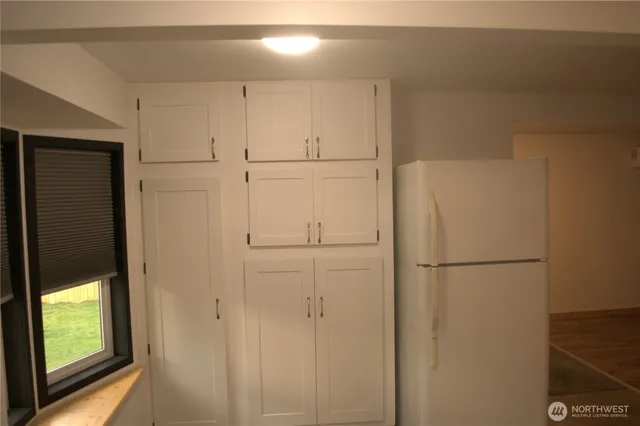 a white refrigerator freezer sitting in a kitchen