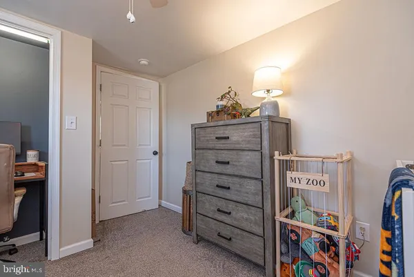 a spacious bedroom with a bed and a flat screen tv
