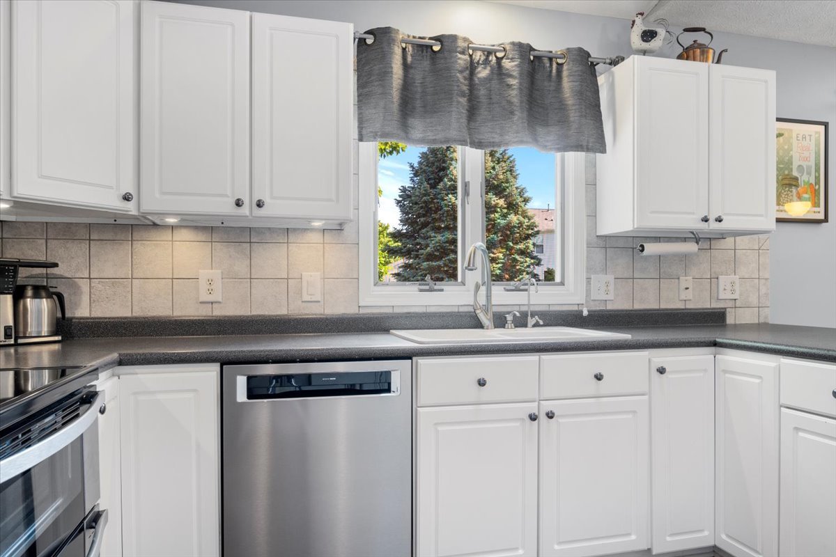3215 Eagle Crest Road Bloomington, IL 61704 - Photo 11 of 35 a kitchen with granite countertop white cabinets and white appliances
