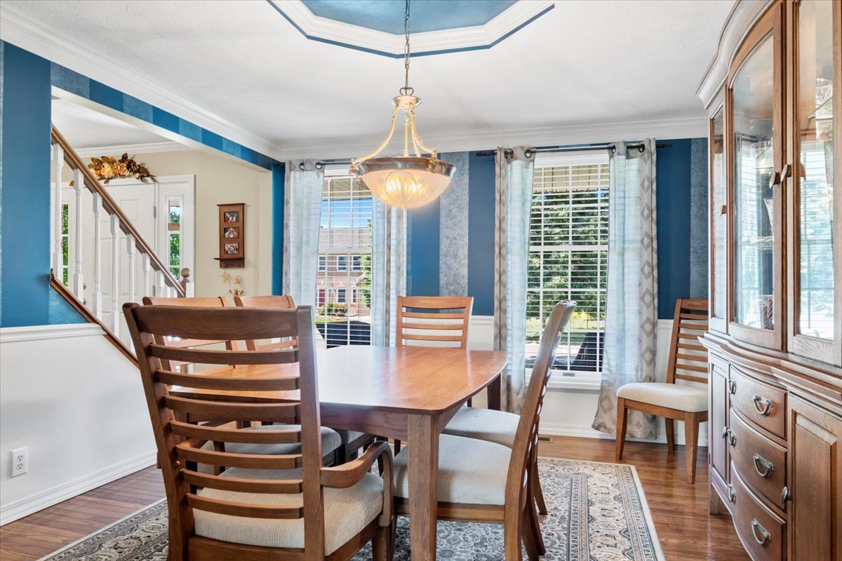 3215 Eagle Crest Road Bloomington, IL 61704 - Photo 16 of 35 a dining room with furniture a chandelier and wooden floor