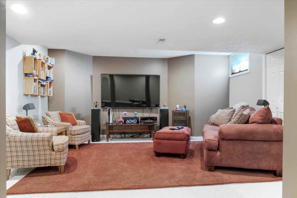3215 Eagle Crest Road Bloomington, IL 61704 - Photo 29 of 35 a living room with furniture and a flat screen tv