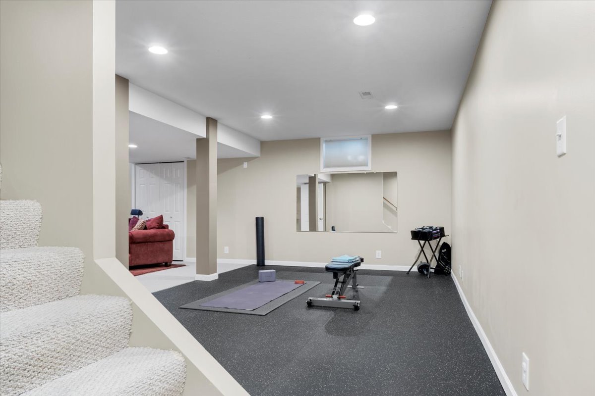 3215 Eagle Crest Road Bloomington, IL 61704 - Photo 30 of 35 a bedroom with furniture and a gym machine