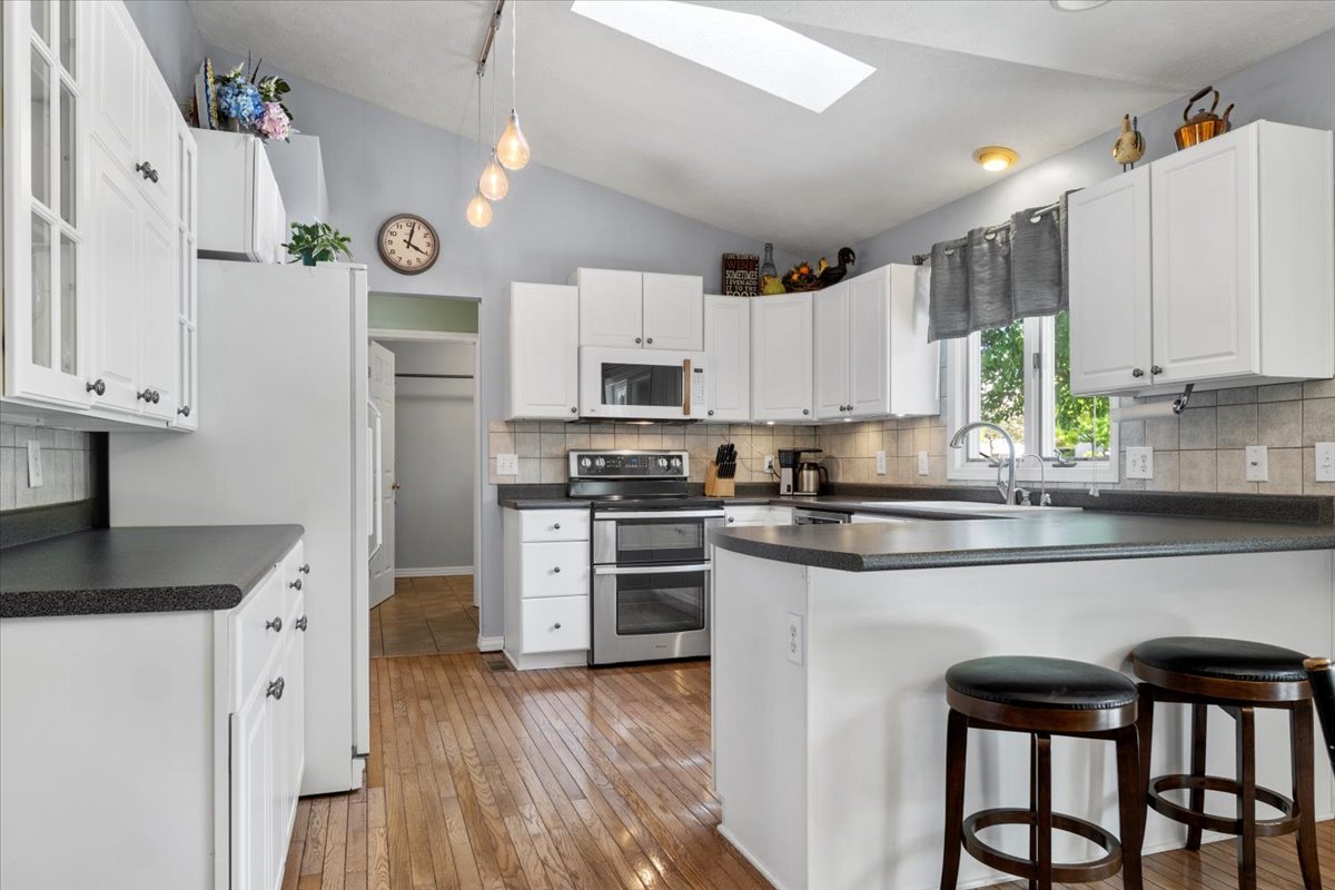 3215 Eagle Crest Road Bloomington, IL 61704 - Photo 10 of 35 a kitchen with granite countertop white cabinets and white appliances