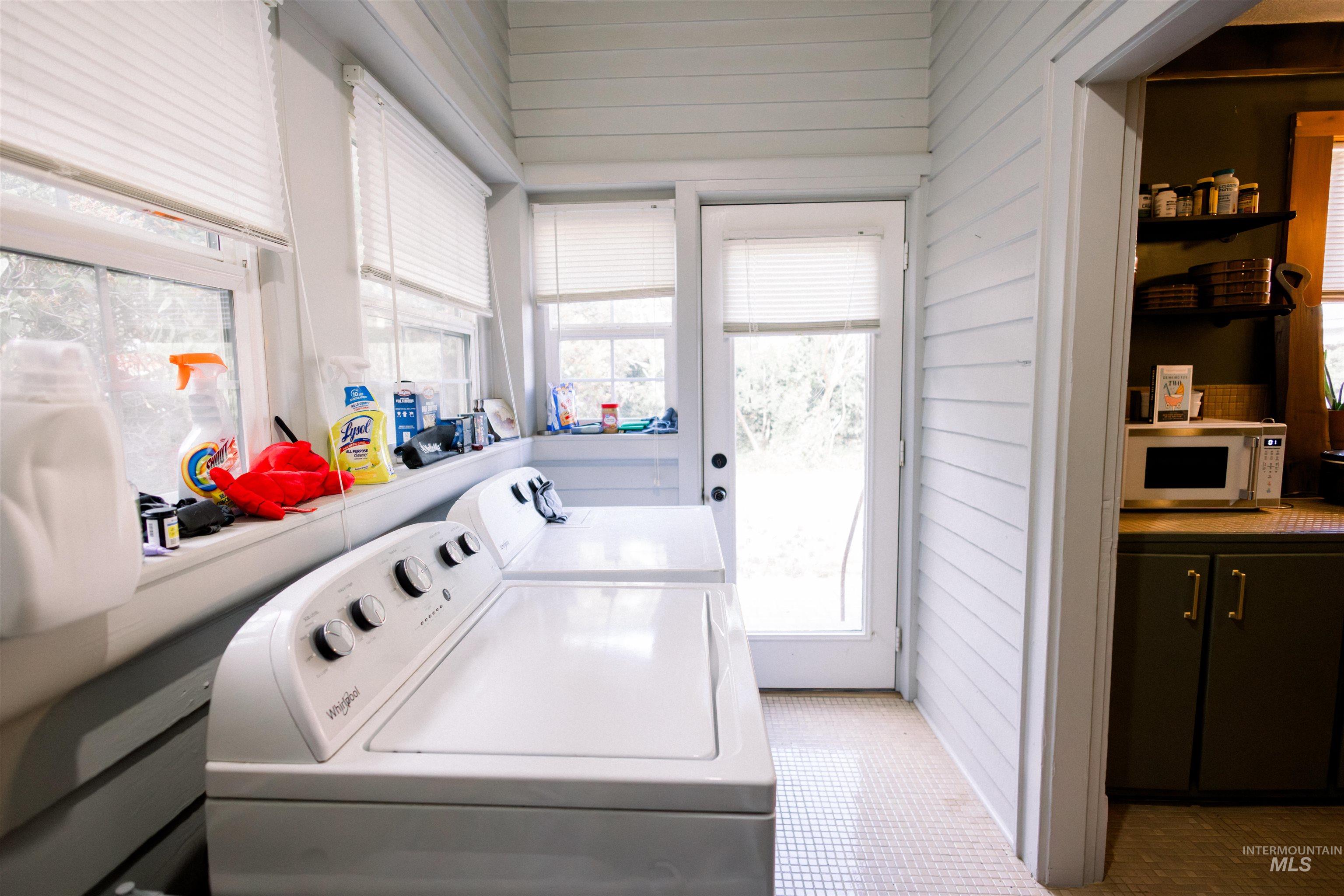450 South 3rd E Street Mountain Home, ID 83647 - Photo 24 of 35 Laundry area with washer and dryer, wooden walls, and light tile patterned floors