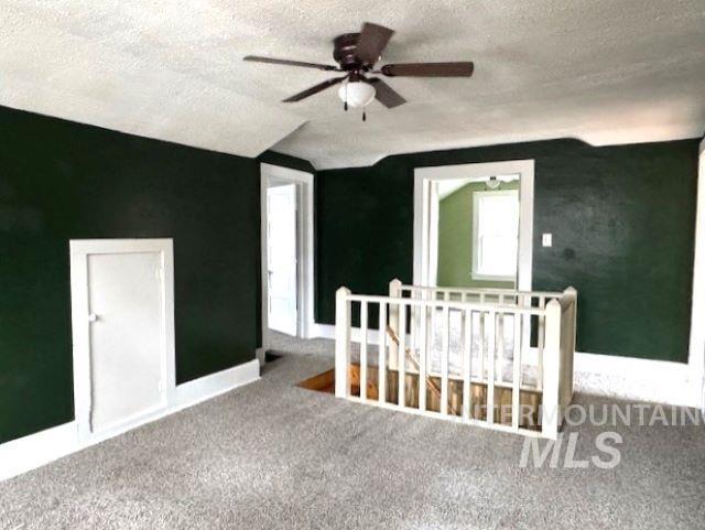 450 South 3rd E Street Mountain Home, ID 83647 - Photo 26 of 35 Additional living space with a textured ceiling, a ceiling fan, and carpet flooring