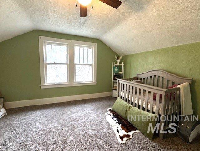 450 South 3rd E Street Mountain Home, ID 83647 - Photo 28 of 35 Bedroom with a textured ceiling, carpet floors, a crib, and ceiling fan
