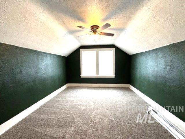 450 South 3rd E Street Mountain Home, ID 83647 - Photo 33 of 35 Bonus room featuring ceiling fan, a baseboard radiator, carpet floors, and a textured ceiling