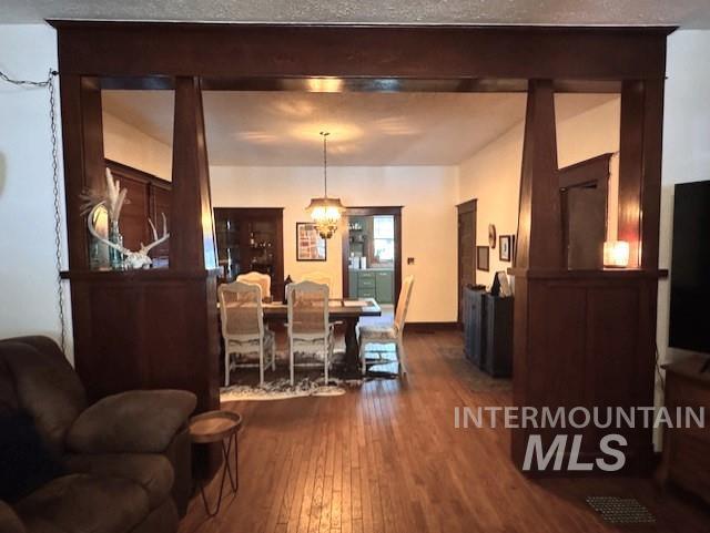 450 South 3rd E Street Mountain Home, ID 83647 - Photo 8 of 35 Dining area featuring dark wood-style floors and a chandelier
