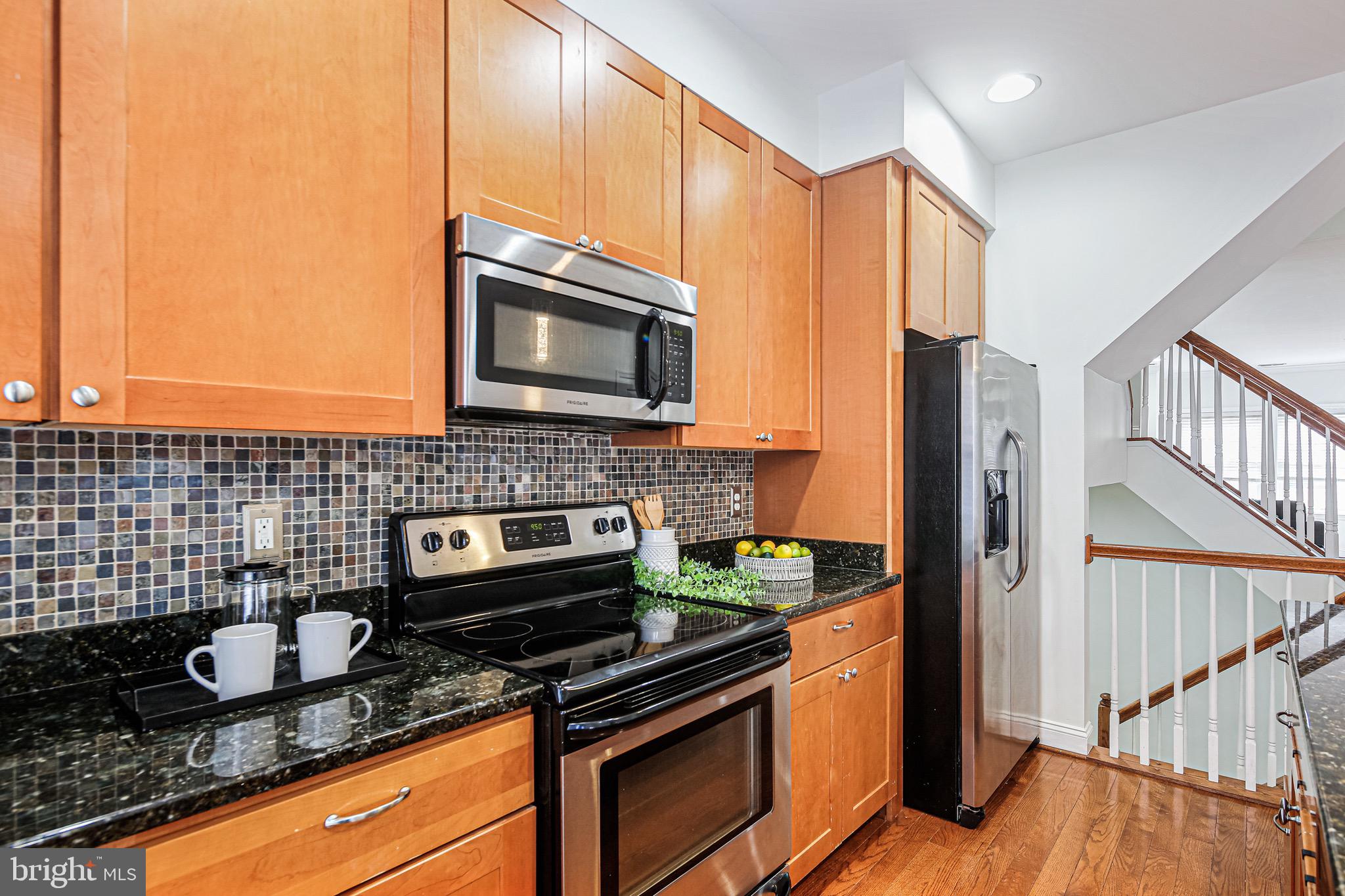 3418 Gunther Way Baltimore, MD 21224 - Photo 11 of 57 a kitchen with granite countertop cabinets stainless steel appliances and a counter space