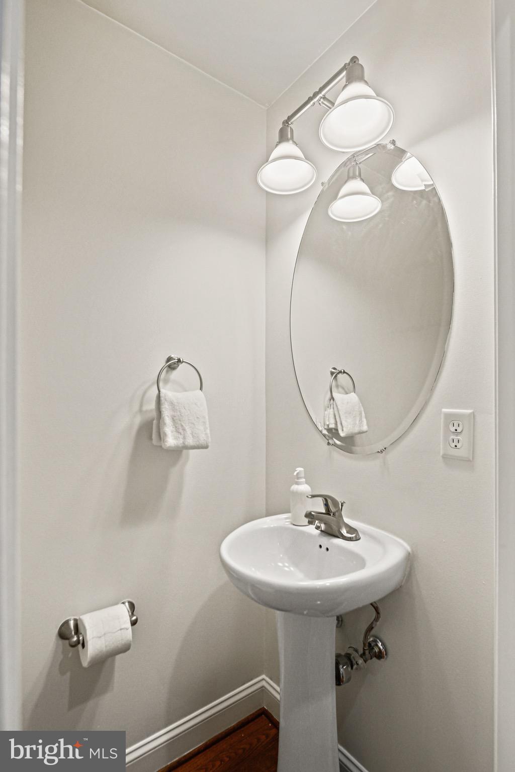 3418 Gunther Way Baltimore, MD 21224 - Photo 20 of 57 a bathroom with a sink a mirror and vanity