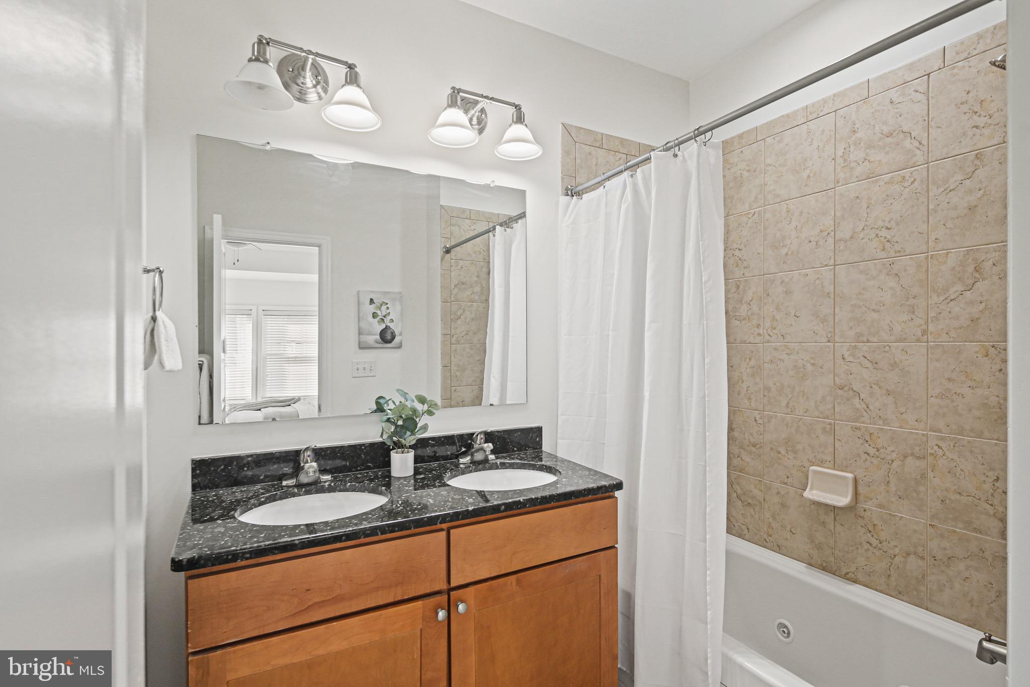 3418 Gunther Way Baltimore, MD 21224 - Photo 26 of 57 a bathroom with a sink and a mirror