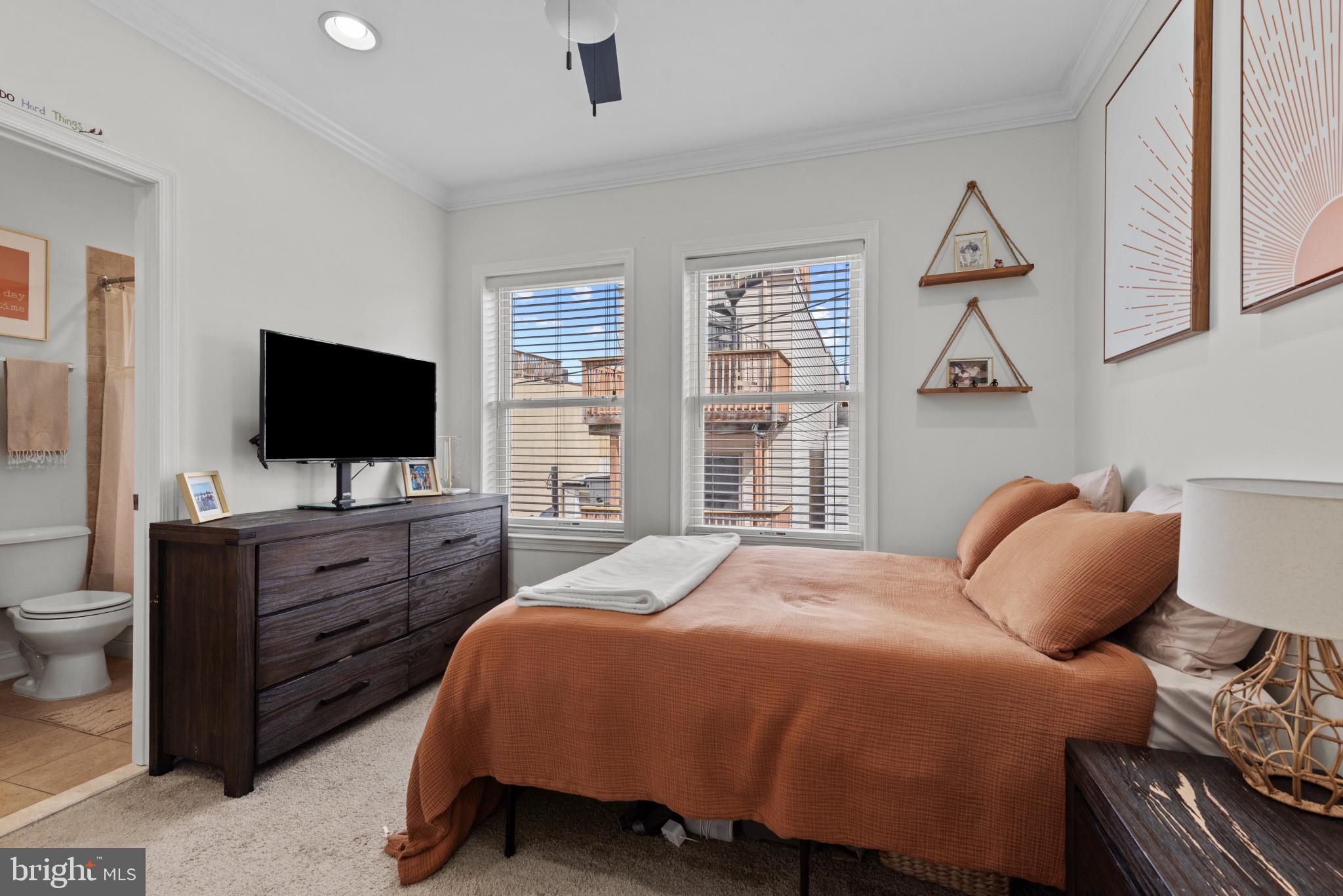 3418 Gunther Way Baltimore, MD 21224 - Photo 29 of 57 a bedroom with a bed and a flat screen tv