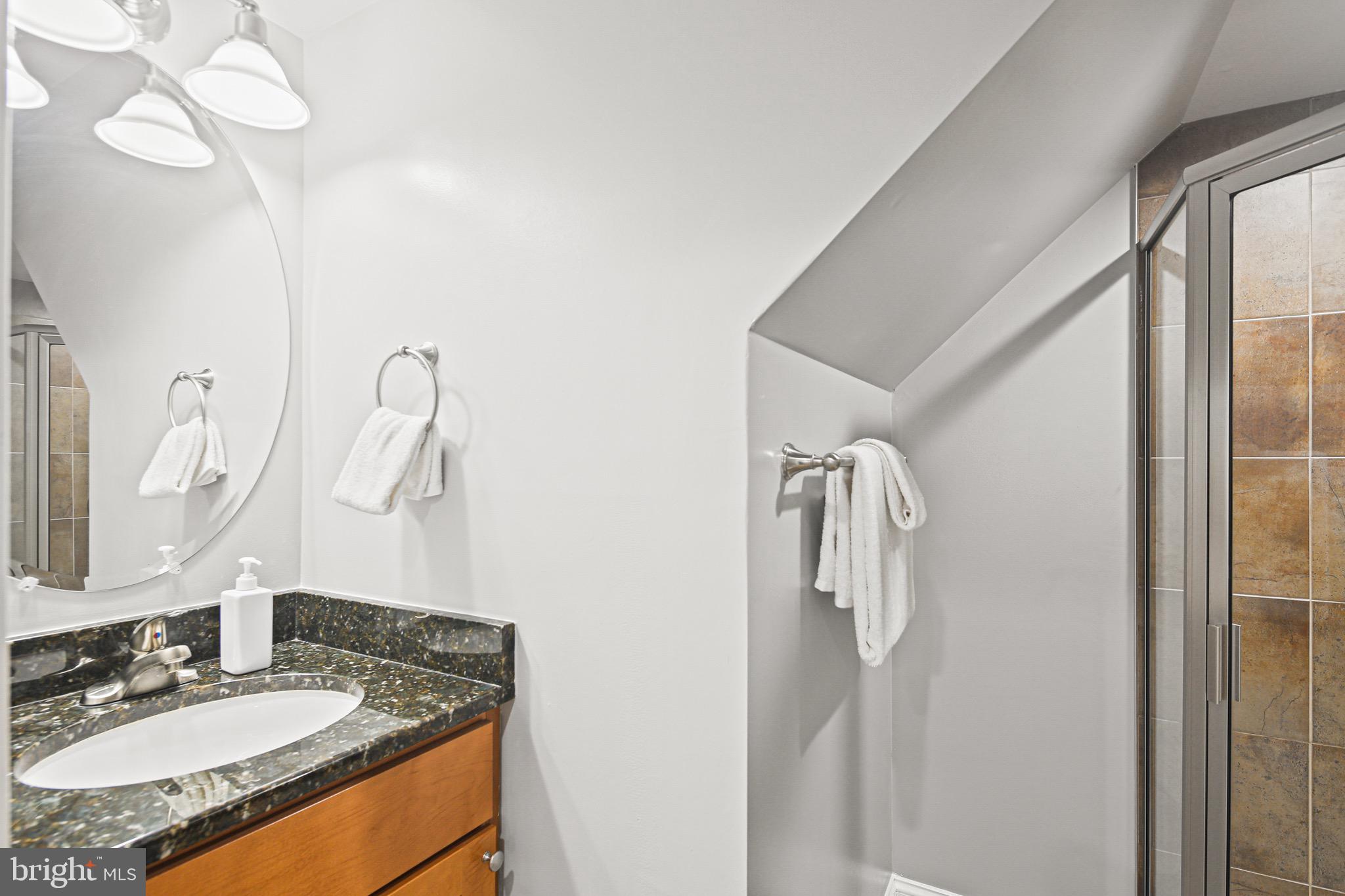 3418 Gunther Way Baltimore, MD 21224 - Photo 35 of 57 a bathroom with a granite countertop sink and a mirror