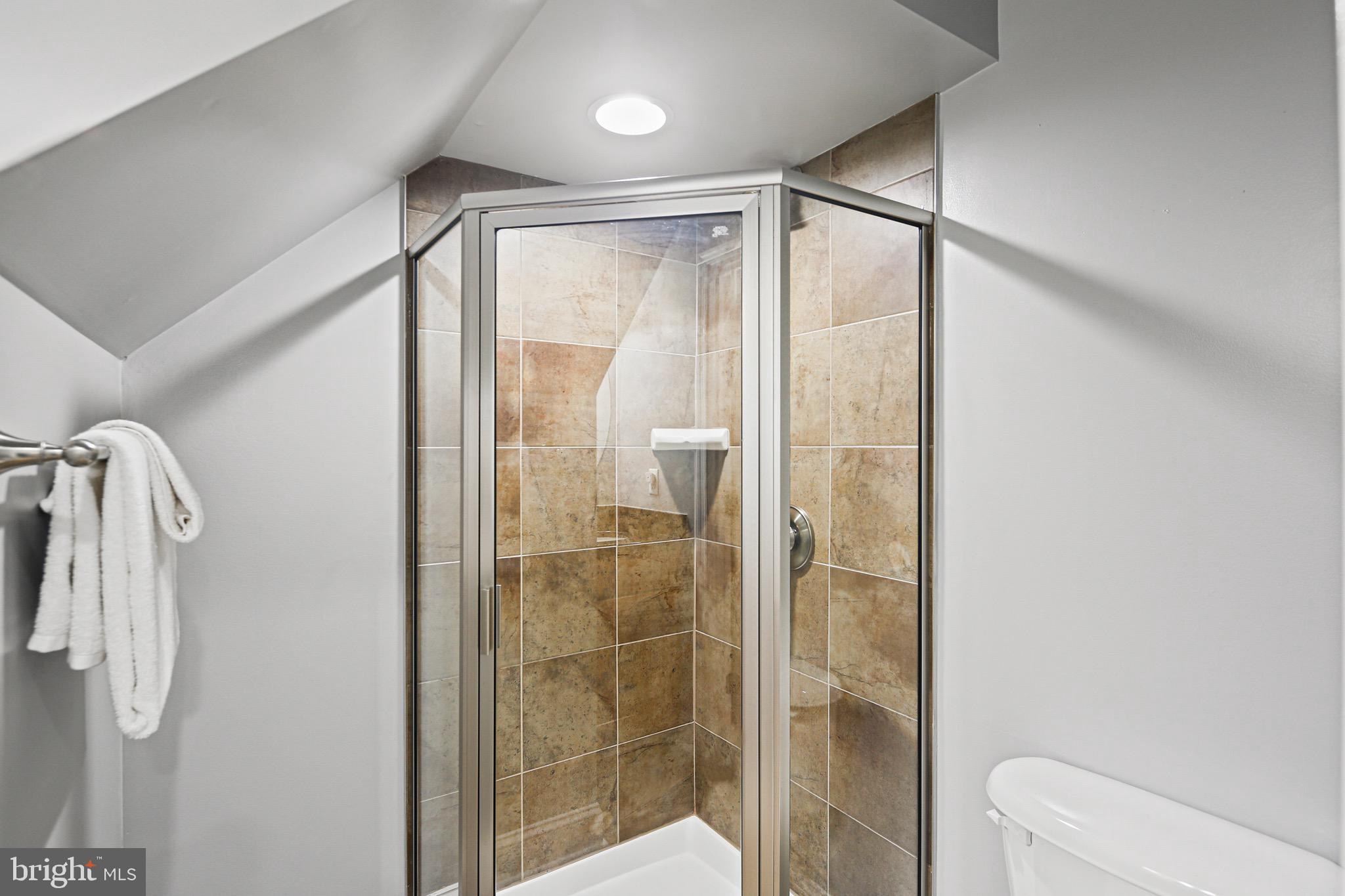 3418 Gunther Way Baltimore, MD 21224 - Photo 36 of 57 a bathroom with a glass shower door