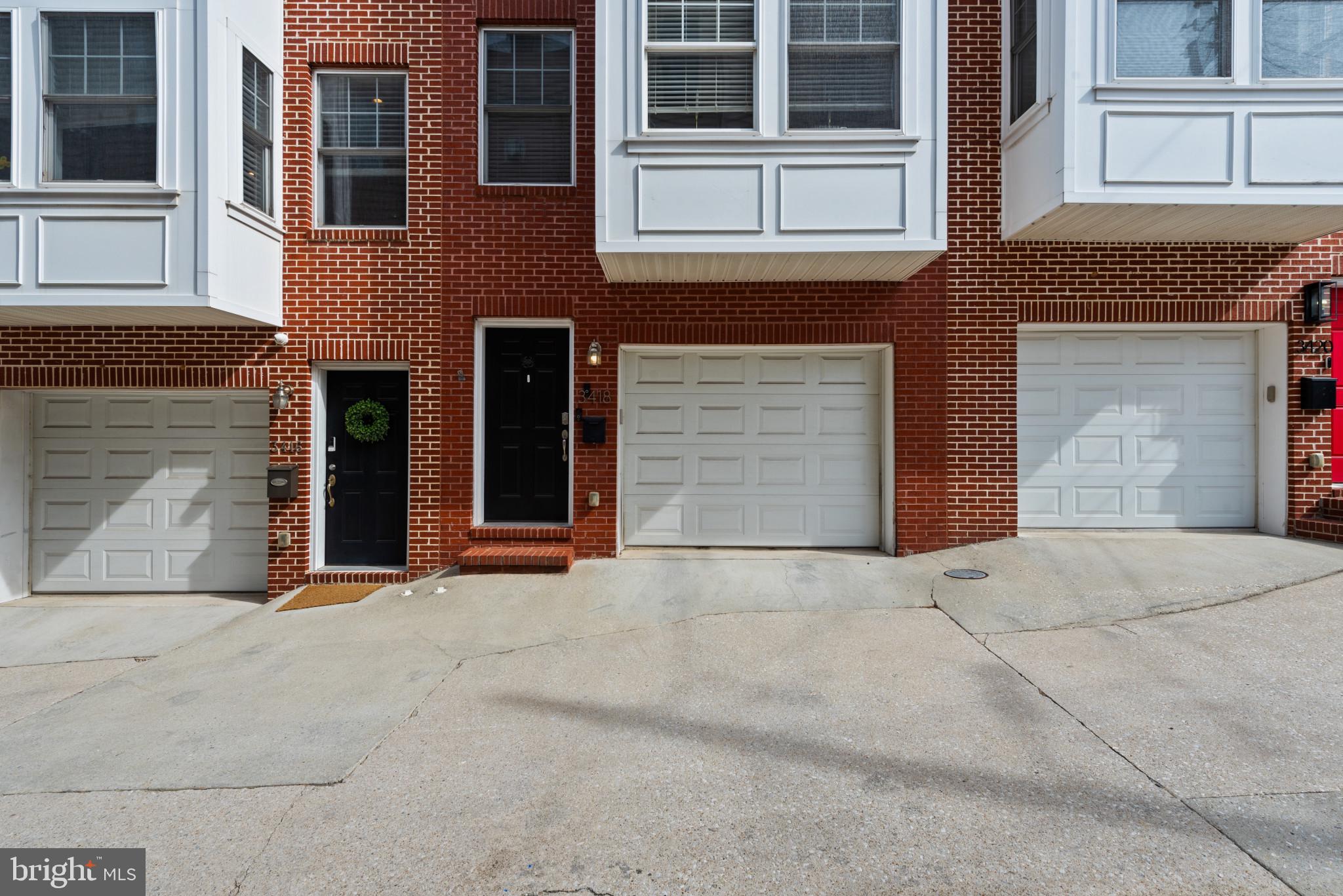 3418 Gunther Way Baltimore, MD 21224 - Photo 54 of 57 a front view of a house with a yard and garage