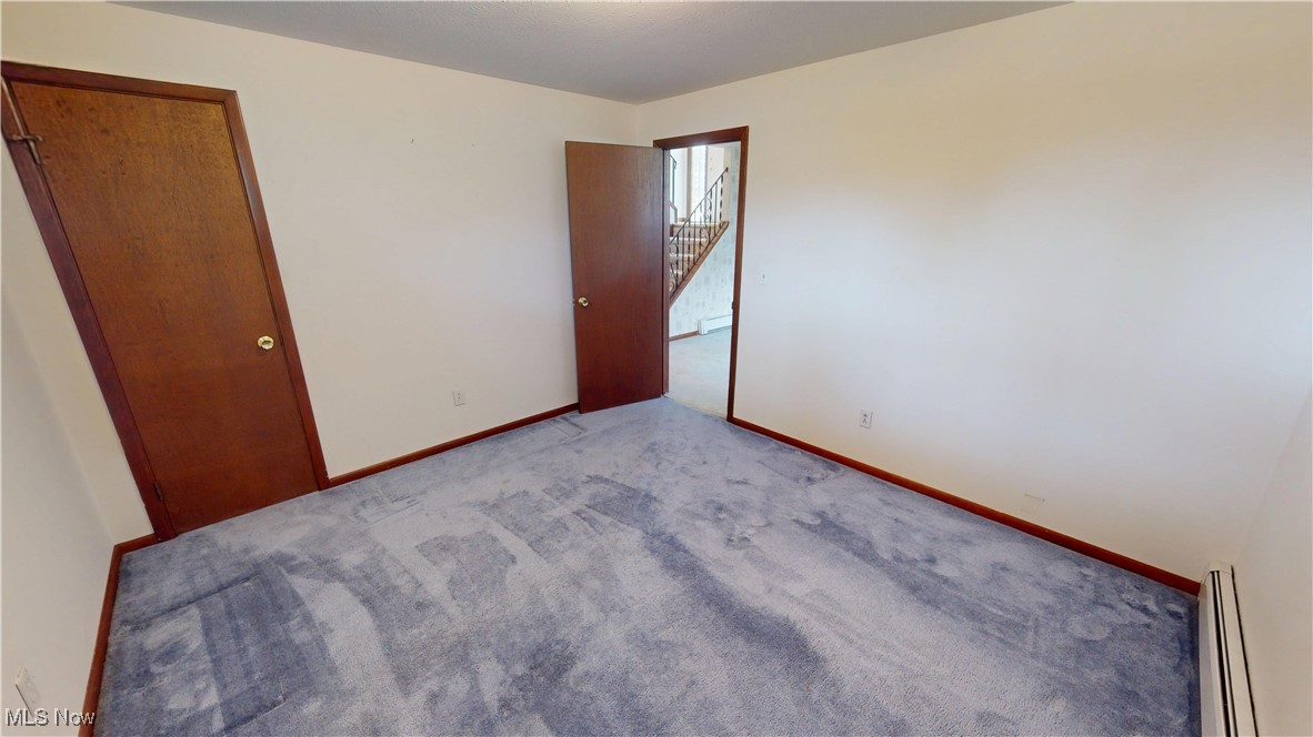 4444 Center Road Brunswick, OH 44212 - Photo 7 of 9 Unfurnished bedroom featuring carpet flooring and a baseboard radiator
