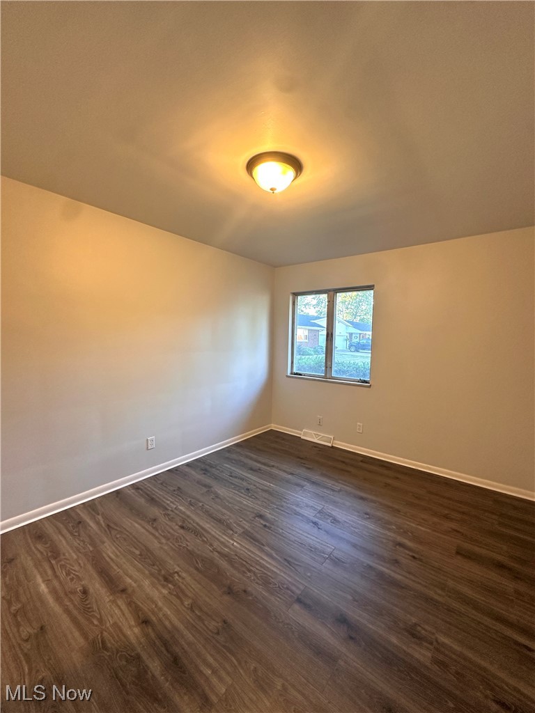 288 Kenridge Road Akron, OH 44333 - Photo 6 of 14 Unfurnished room with baseboards and dark wood-style flooring