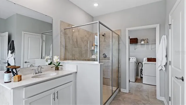a bathroom with a shower sink and mirror