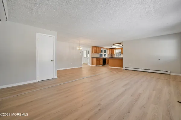 a large kitchen with stainless steel appliances granite countertop a sink and wooden cabinets