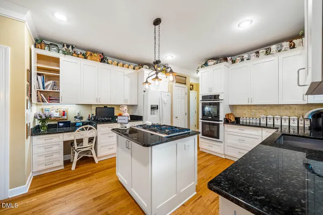 a kitchen with stove and cabinets