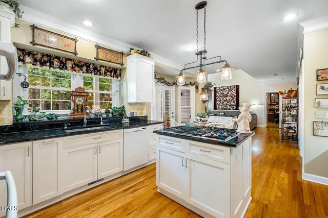 a kitchen with stainless steel appliances granite countertop a stove and a sink