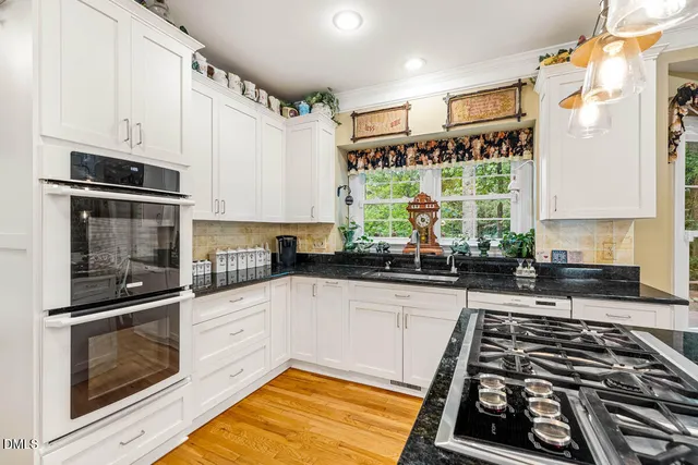 a kitchen with stainless steel appliances a stove a sink and a microwave
