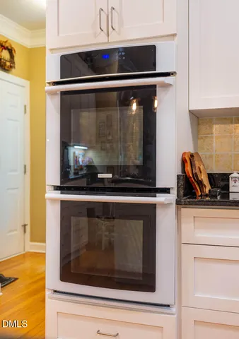 a stove top oven sitting inside of a kitchen