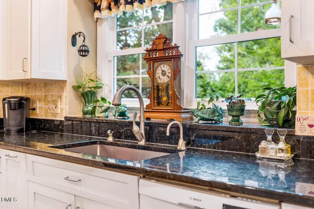 a kitchen with granite countertop a sink and a window