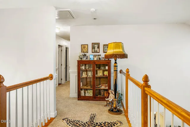 a bedroom with a bed and a lamp on dresser