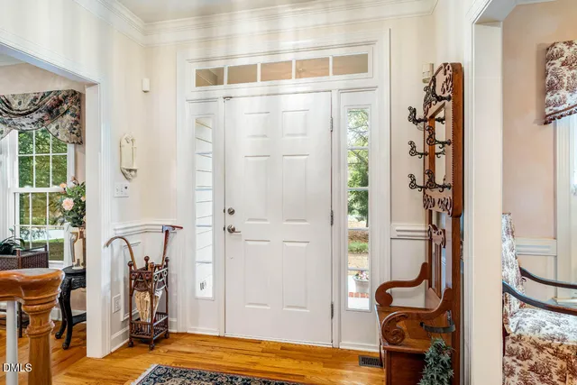 a view of an entryway with wooden floor and a livingroom view